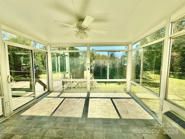 unfurnished sunroom featuring ceiling fan