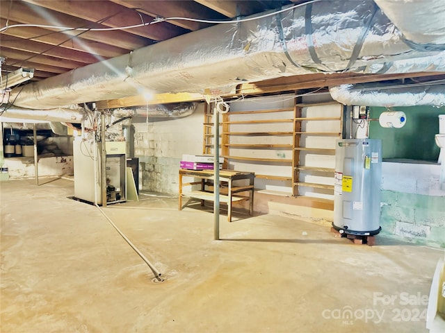 basement with heating unit and electric water heater