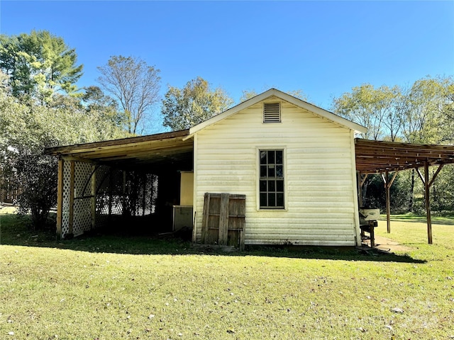 exterior space with a yard and a carport