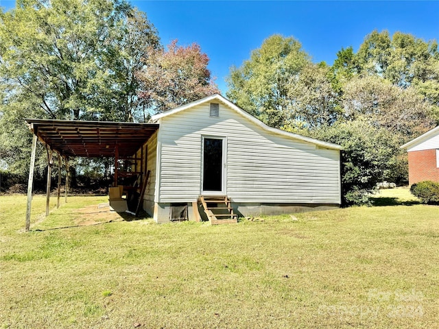 view of outdoor structure featuring a lawn