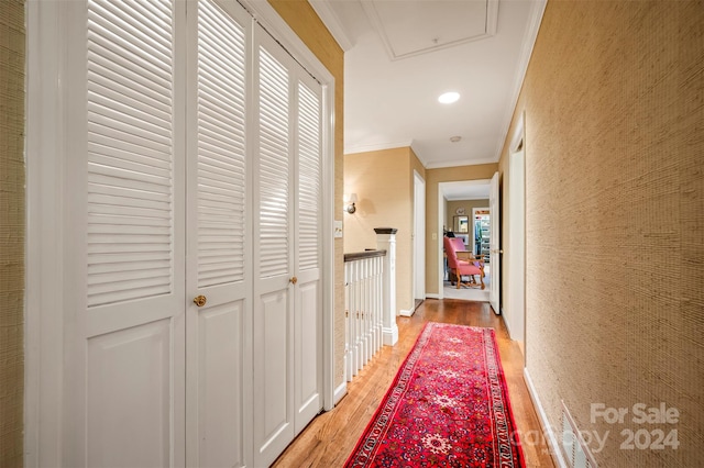 hallway featuring ornamental molding and hardwood / wood-style floors