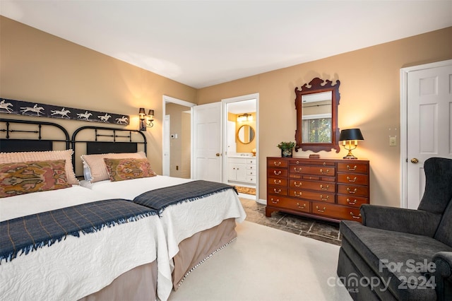 bedroom with ensuite bath and carpet