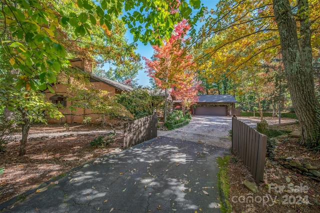 obstructed view of property with a garage