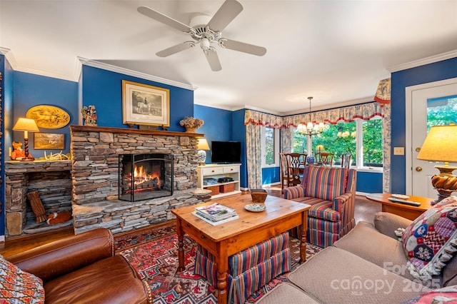 living room with ceiling fan with notable chandelier, crown molding, and a fireplace