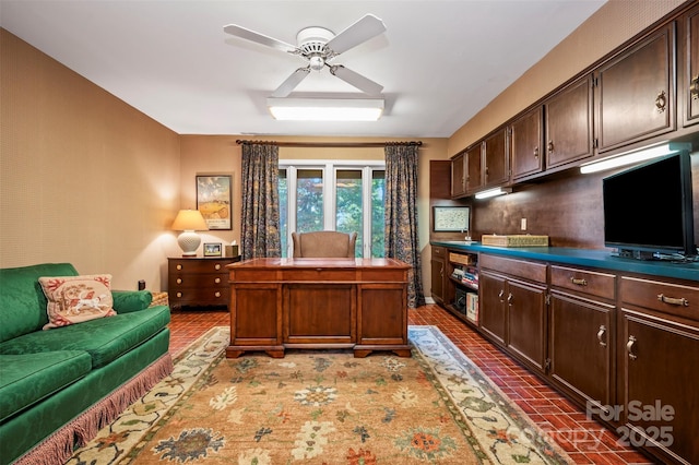 office area featuring brick floor and ceiling fan