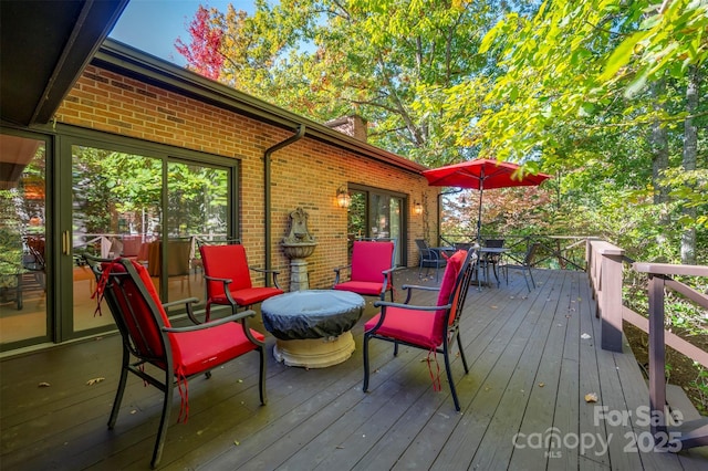 wooden terrace with outdoor dining area