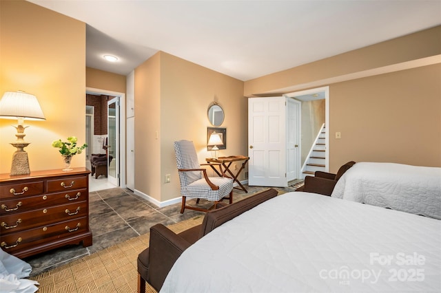 bedroom featuring a closet, baseboards, and a walk in closet