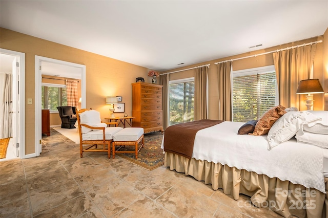 bedroom featuring visible vents and multiple windows