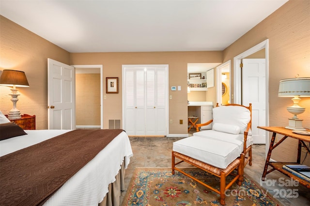 bedroom with baseboards, visible vents, and a closet