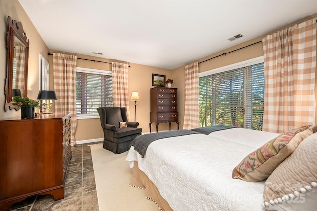 bedroom with visible vents and baseboards