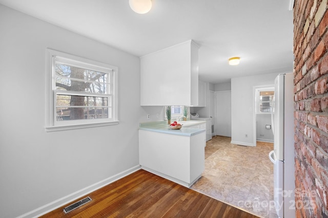 kitchen featuring washer / clothes dryer, white cabinets, sink, and white fridge