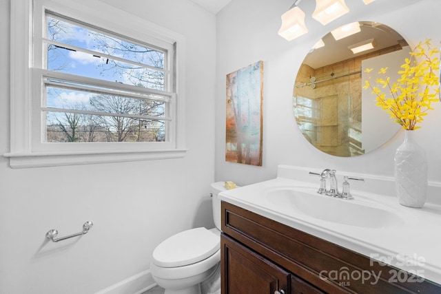 bathroom with vanity, toilet, and walk in shower