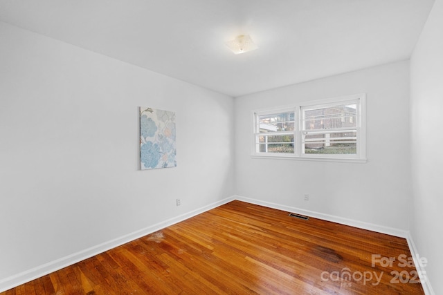 spare room with wood-type flooring