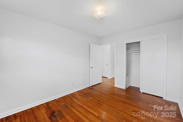 unfurnished bedroom featuring a closet and wood-type flooring