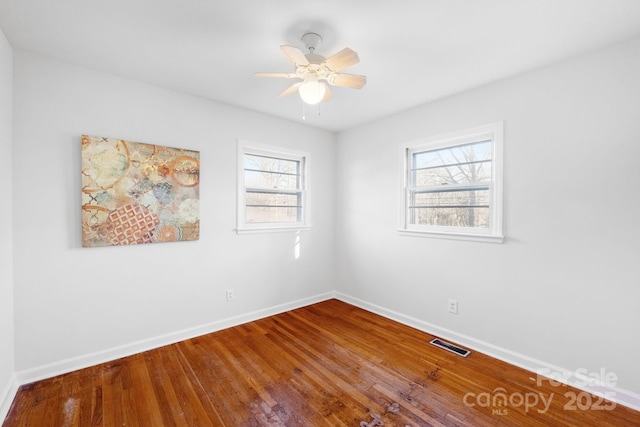 empty room featuring hardwood / wood-style flooring and ceiling fan