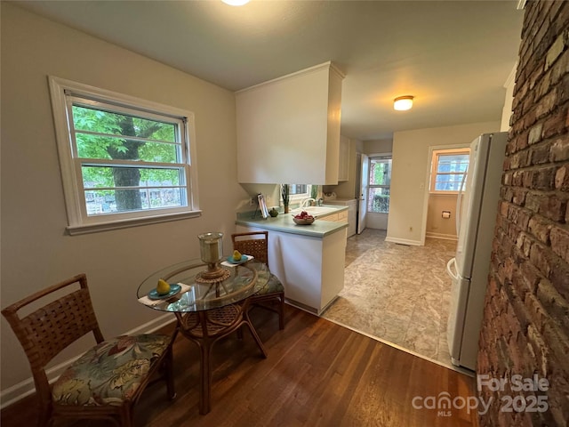 1727 Hartford Dr, Gastonia, NC 28052 - kitchen with freestanding refrigerator, light wood-style floors, a sink, light countertops, and baseboards