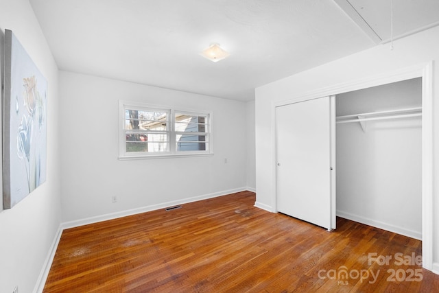 1727 Hartford Dr, Gastonia, NC 28052 - unfurnished bedroom with attic access, wood finished floors, a closet, and baseboards