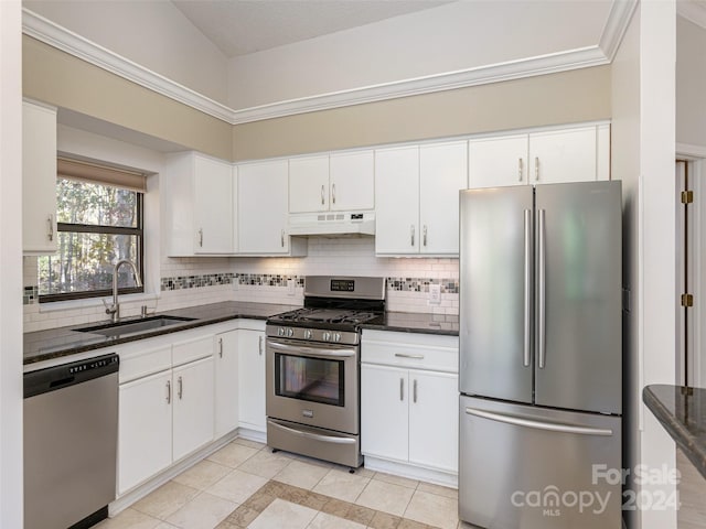 kitchen with white cabinets, decorative backsplash, appliances with stainless steel finishes, light tile patterned flooring, and sink