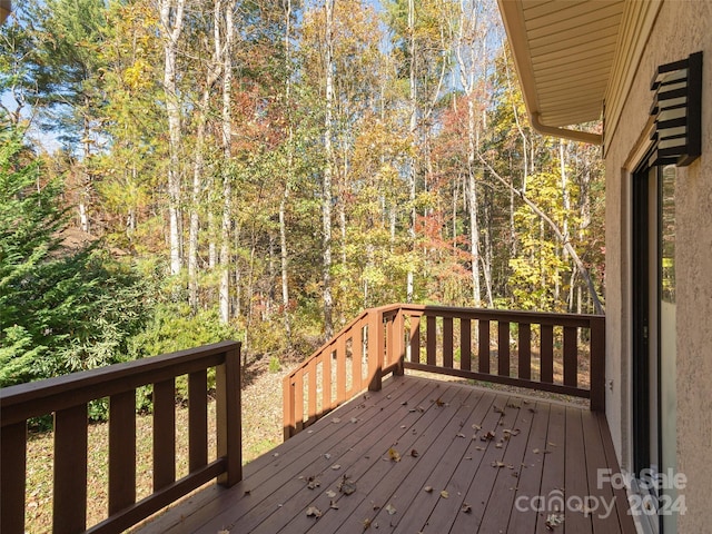 wooden deck with a forest view
