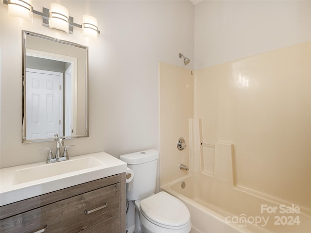 bathroom with shower / tub combination, vanity, and toilet