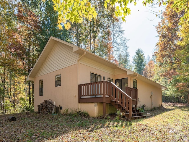 view of side of property with a wooden deck