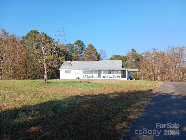 ranch-style house with a porch and a front yard