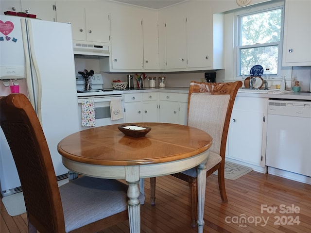 kitchen with white cabinets, light hardwood / wood-style floors, and white appliances