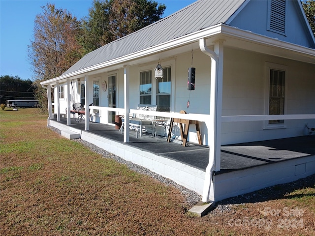 exterior space featuring a porch and a yard