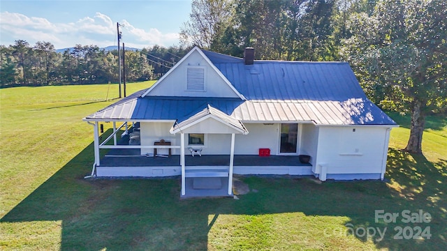 rear view of property with a patio area and a yard