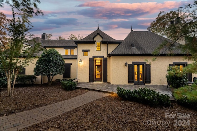 view of front of home with a patio area and french doors