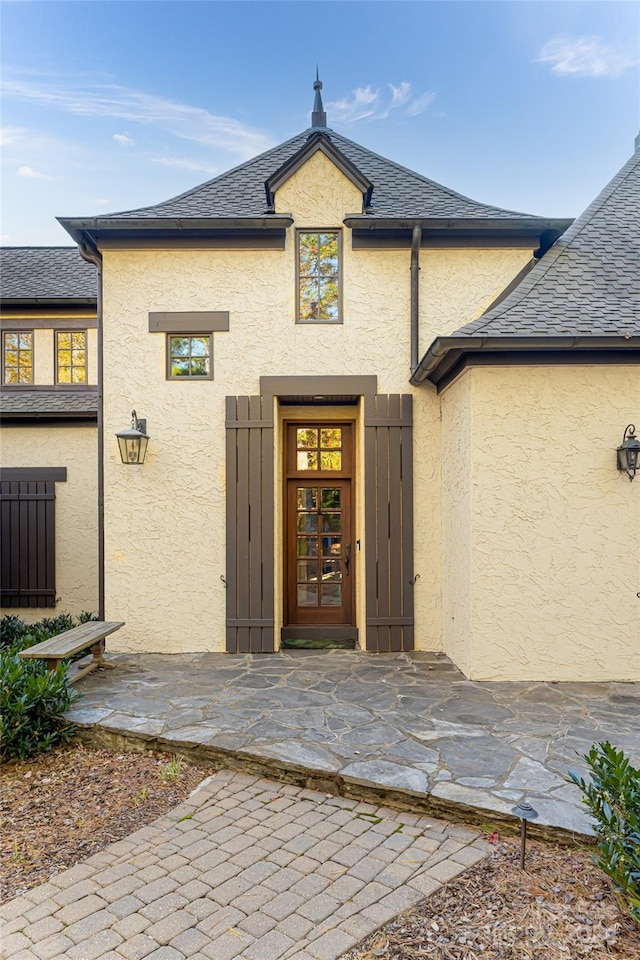 view of exterior entry featuring a patio