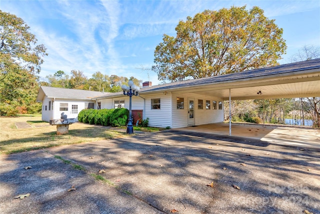 ranch-style house featuring a carport