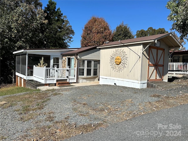 manufactured / mobile home with a storage unit and a sunroom