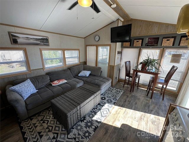 living room with ceiling fan, dark hardwood / wood-style floors, wooden walls, and lofted ceiling with beams