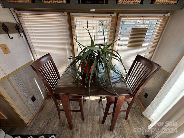 dining space with wood-type flooring