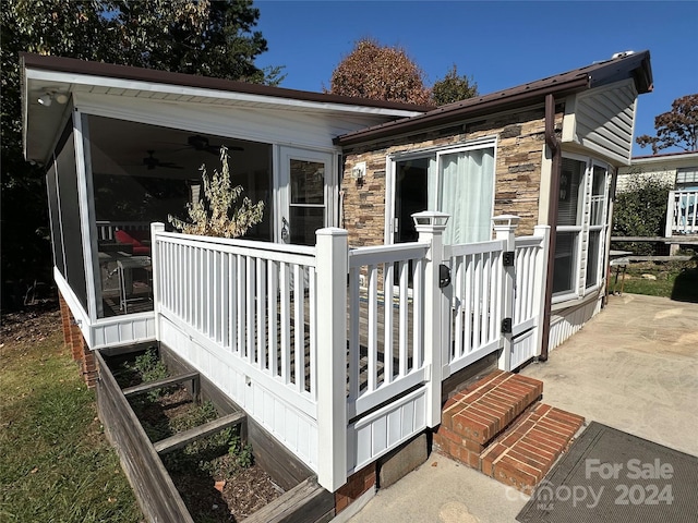 exterior space with ceiling fan