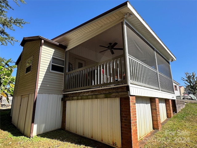 view of side of home with a sunroom and ceiling fan