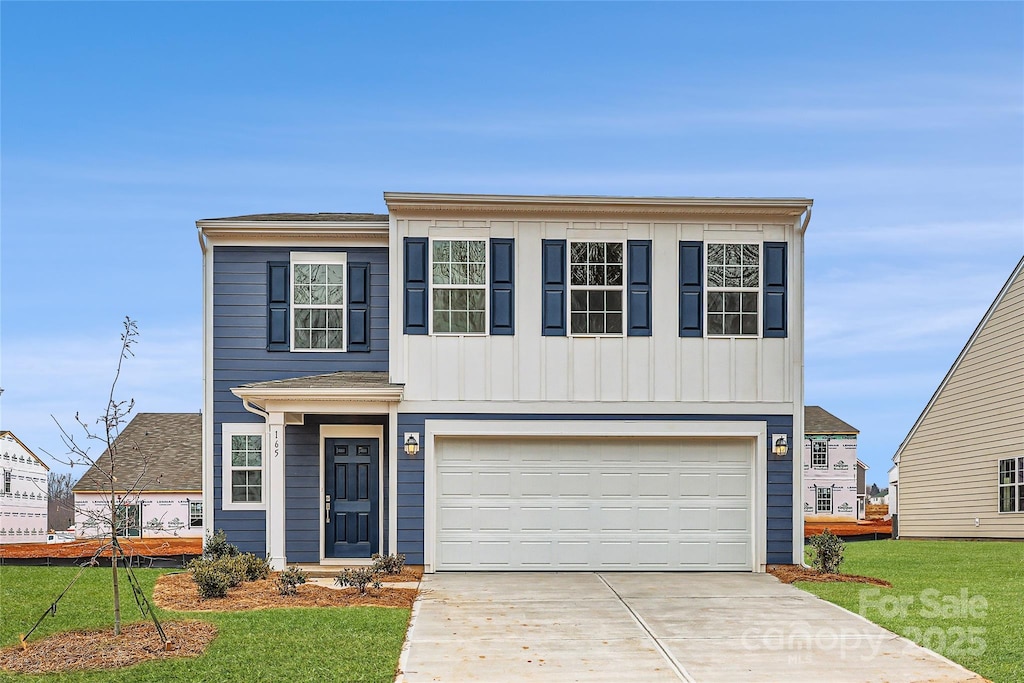 view of front facade featuring a garage and a front lawn