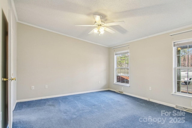 carpeted empty room with ornamental molding, ceiling fan, and a textured ceiling