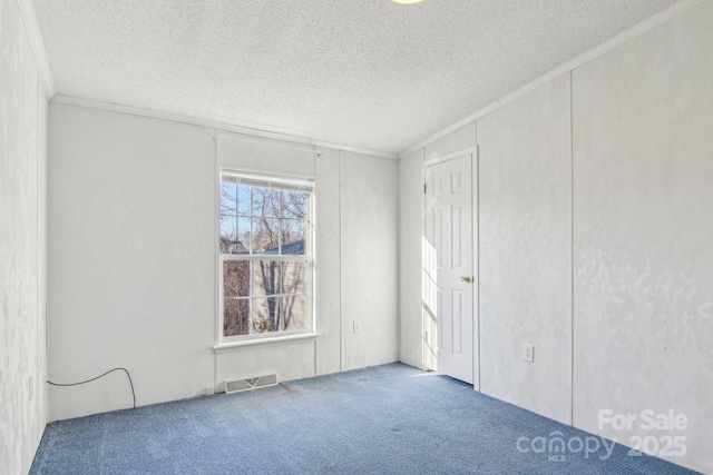 unfurnished bedroom featuring crown molding, carpet floors, and a textured ceiling