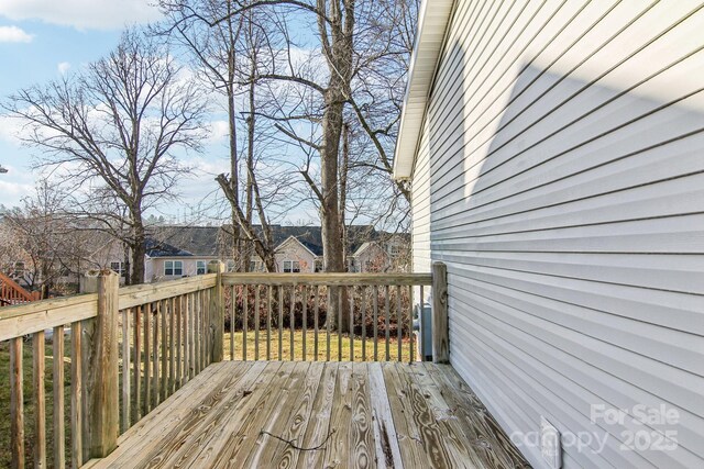 wooden deck with a lawn