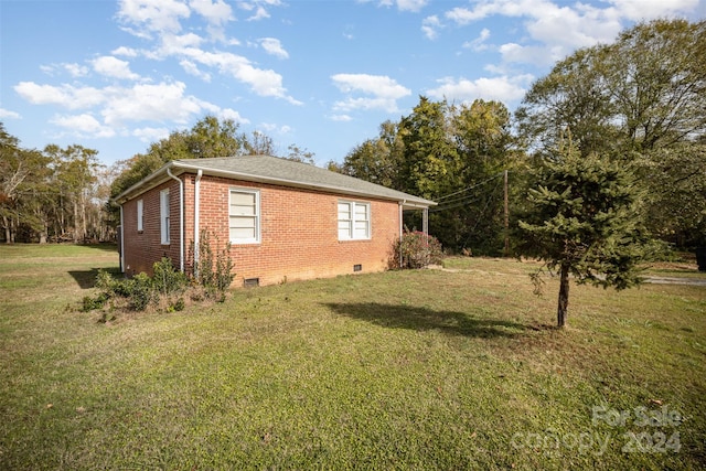 view of property exterior with a yard