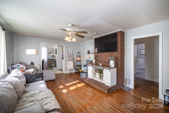 living room featuring a textured ceiling, dark hardwood / wood-style floors, and ceiling fan