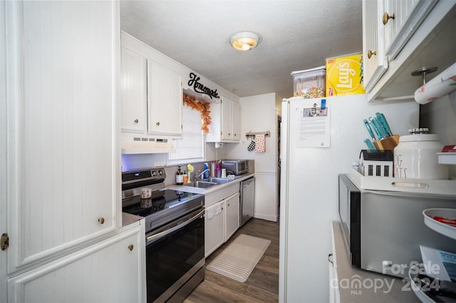 kitchen featuring a textured ceiling, ventilation hood, stainless steel appliances, dark wood-type flooring, and white cabinets