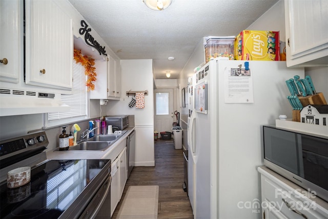 kitchen with dark hardwood / wood-style floors, a textured ceiling, range hood, white cabinetry, and stainless steel appliances