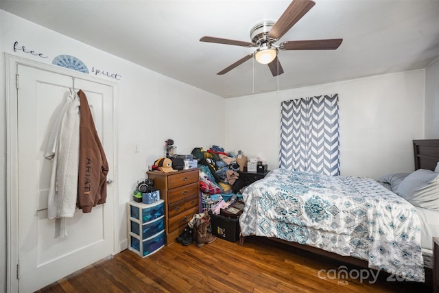 bedroom featuring dark hardwood / wood-style flooring, a closet, and ceiling fan