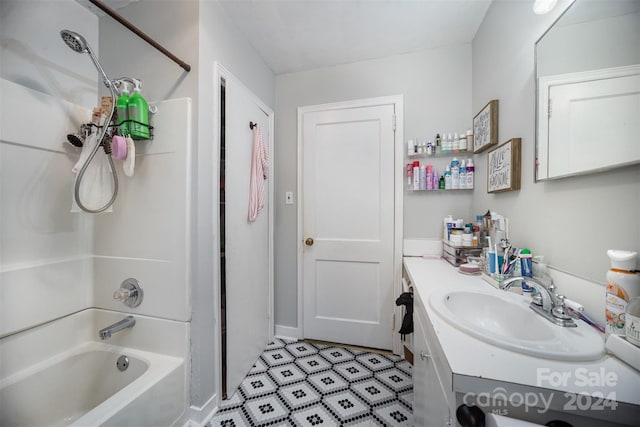 bathroom with vanity and shower / washtub combination