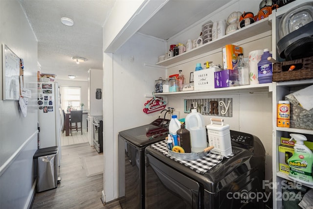 interior space featuring hardwood / wood-style floors, washing machine and dryer, and a textured ceiling