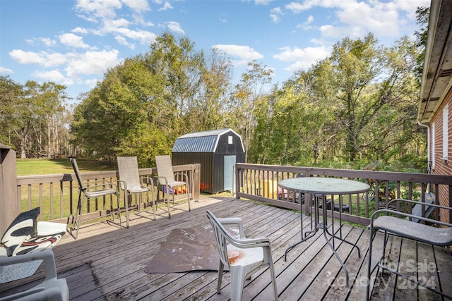 wooden terrace featuring a storage unit