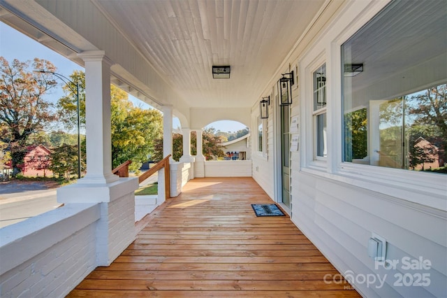 wooden terrace with a porch